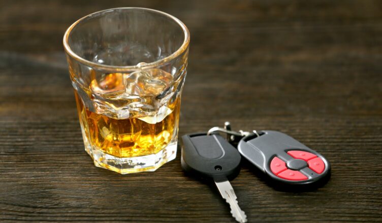 een glas alcohol naast een autosleutel